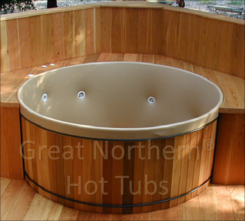 <p>Cedar hot tub with flush-seating deck surrounding half of the tub and showing customizable jets.</p>